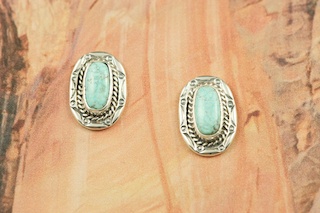 Genuine Number 8 Mine Turquoise set in Sterling Silver Post Earrings. The Number 8 mine is located in Eureka County Nevada. Since 1976 there has been no Number 8 Turquoise mined. There is however, an existing stock pile that Mr. Dowell Ward, the last owner of the Number 8 mine, had stocked away for later sorting. The Turquoise is a collector's item--because once the reserve is gone there will be no more material released onto the market. The Gold Mining Company owns the claim to the Number 8 mine and it has been swallowed up by the gold mining operations. This is some of the last Number 8 Turquoise to be had and will be a great addition to your collection. Created by Navajo Artist Lucy Valencia. Signed L.J. by the artist.